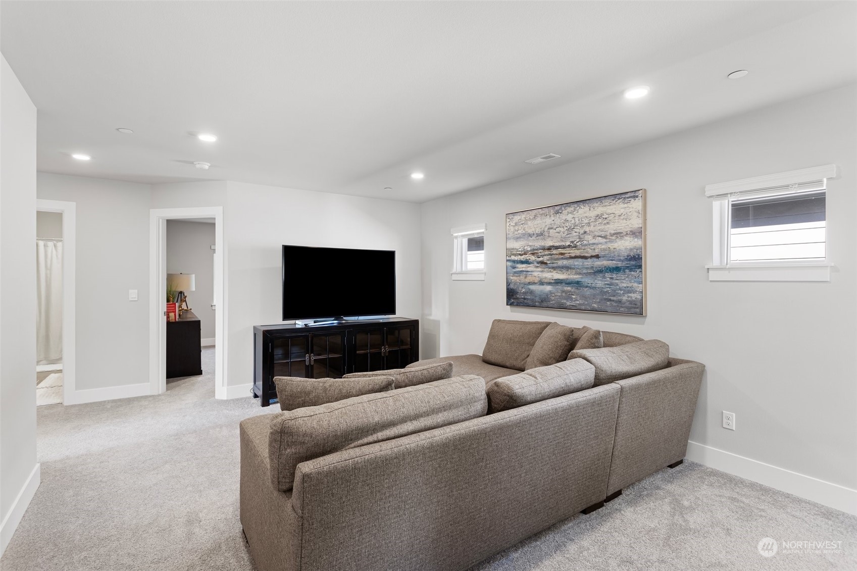2124 229th Place Southwest Bothell, WA 98021 - Photo 27 of 37 a living room with furniture and a flat screen tv