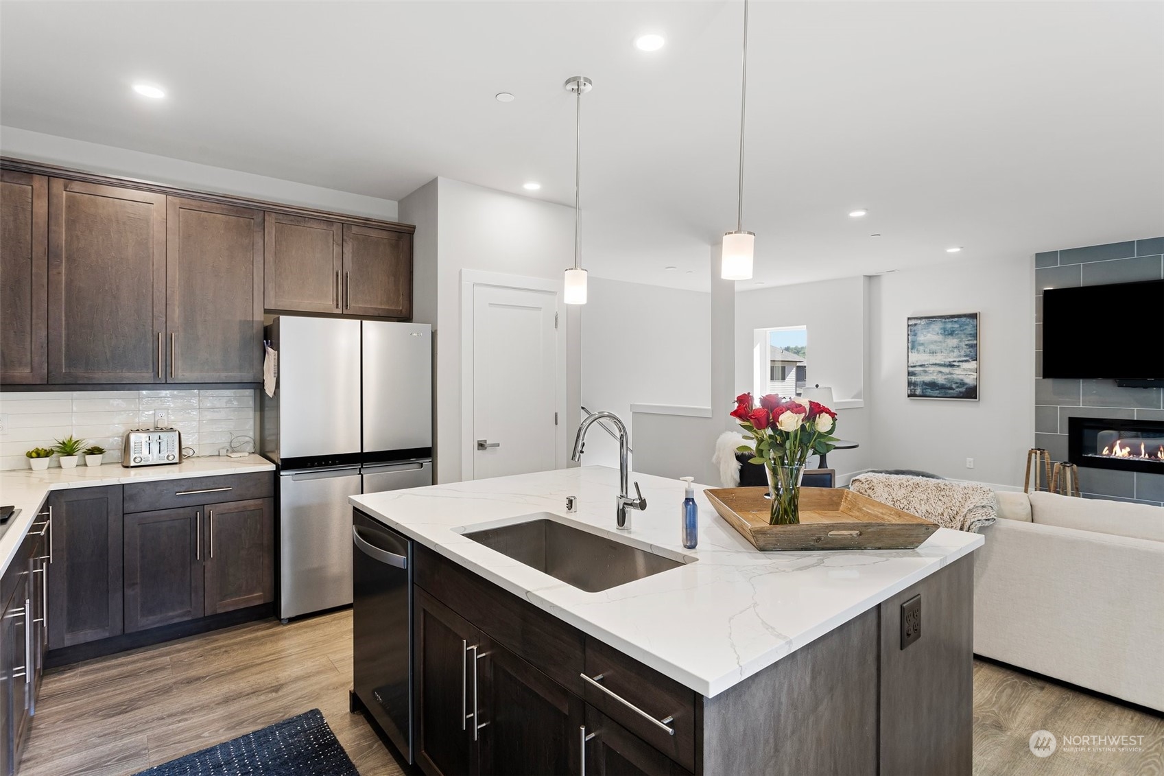 2124 229th Place Southwest Bothell, WA 98021 - Photo 10 of 37 a kitchen with stainless steel appliances a sink a counter top space cabinets and wooden floor