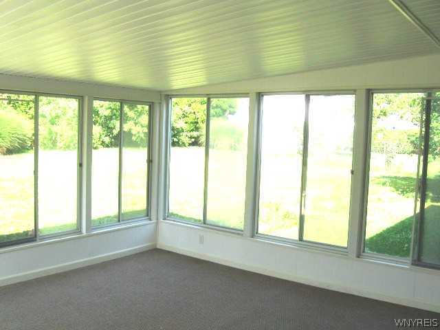 8 Standish Road Lockport City, NY 14094 - Photo 7 of 16 Other. 3 season room opens to a fully fenced back