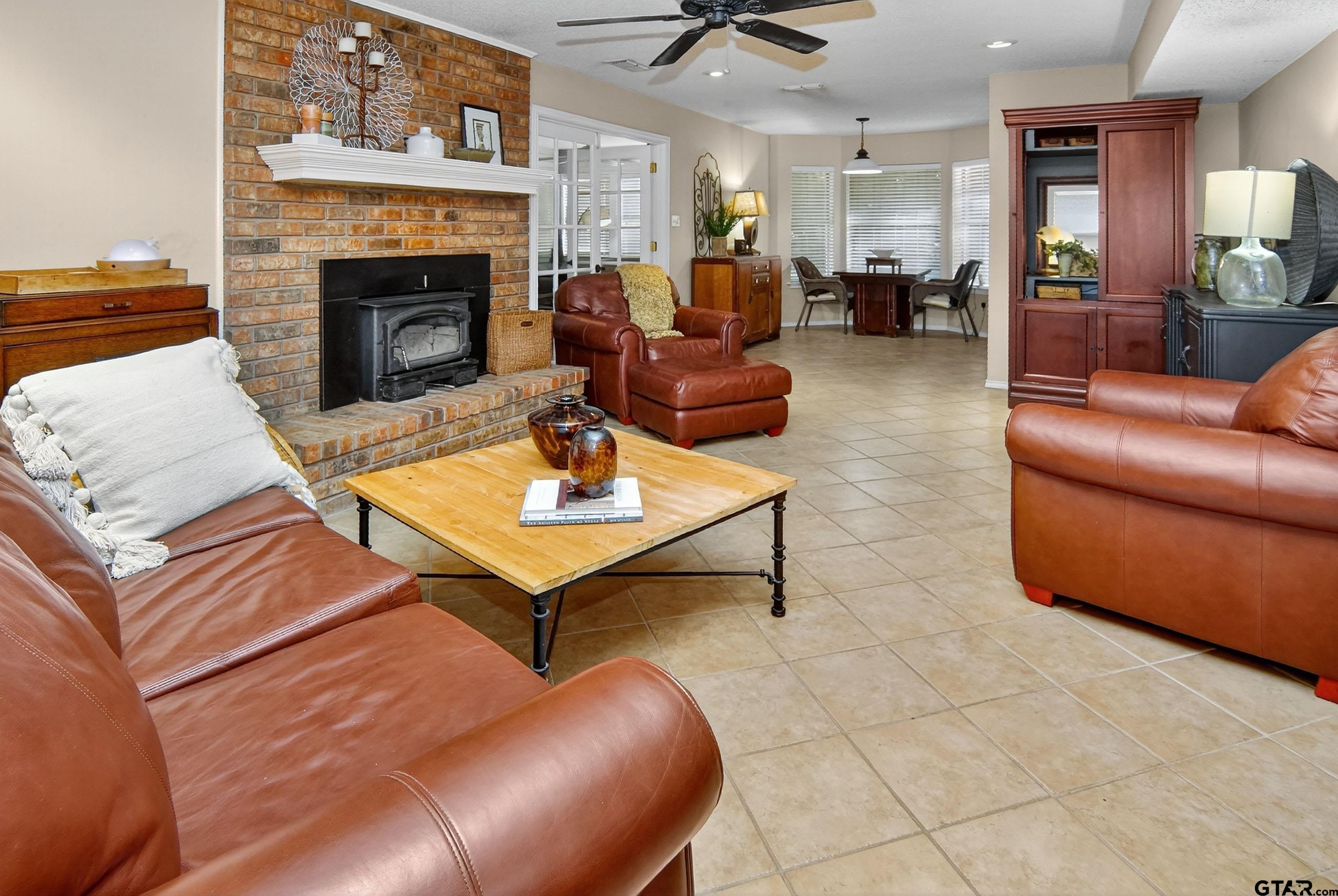 810 Jeanell Street Quitman, TX 75783 - Photo 11 of 37 a living room with furniture a fireplace and a table
