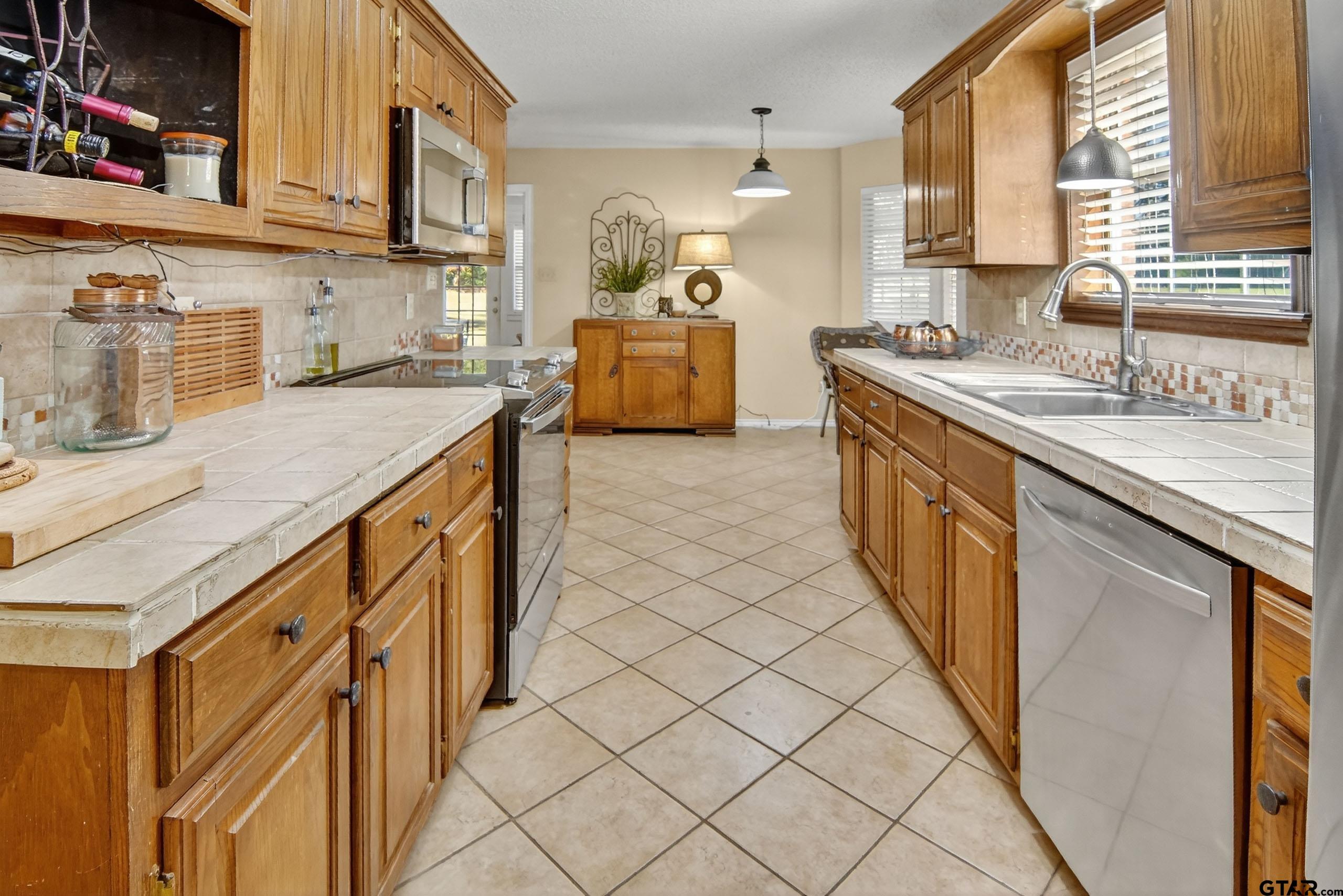 810 Jeanell Street Quitman, TX 75783 - Photo 16 of 37 a kitchen with stainless steel appliances granite countertop a sink and cabinets