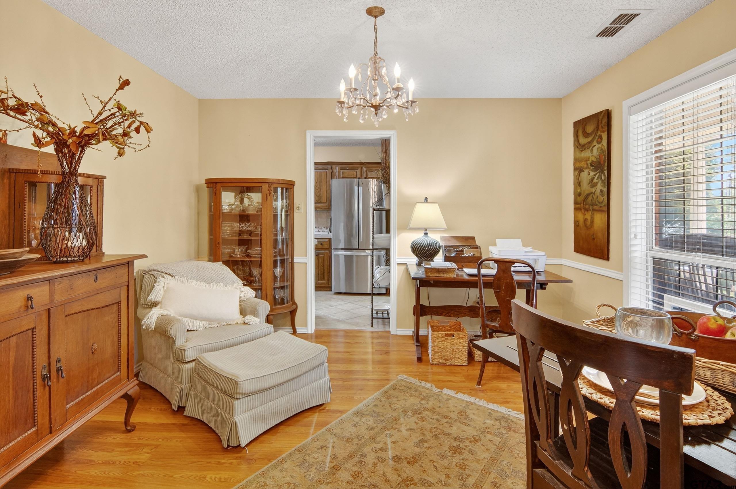 810 Jeanell Street Quitman, TX 75783 - Photo 18 of 37 a living room with furniture a chandelier and a dining table