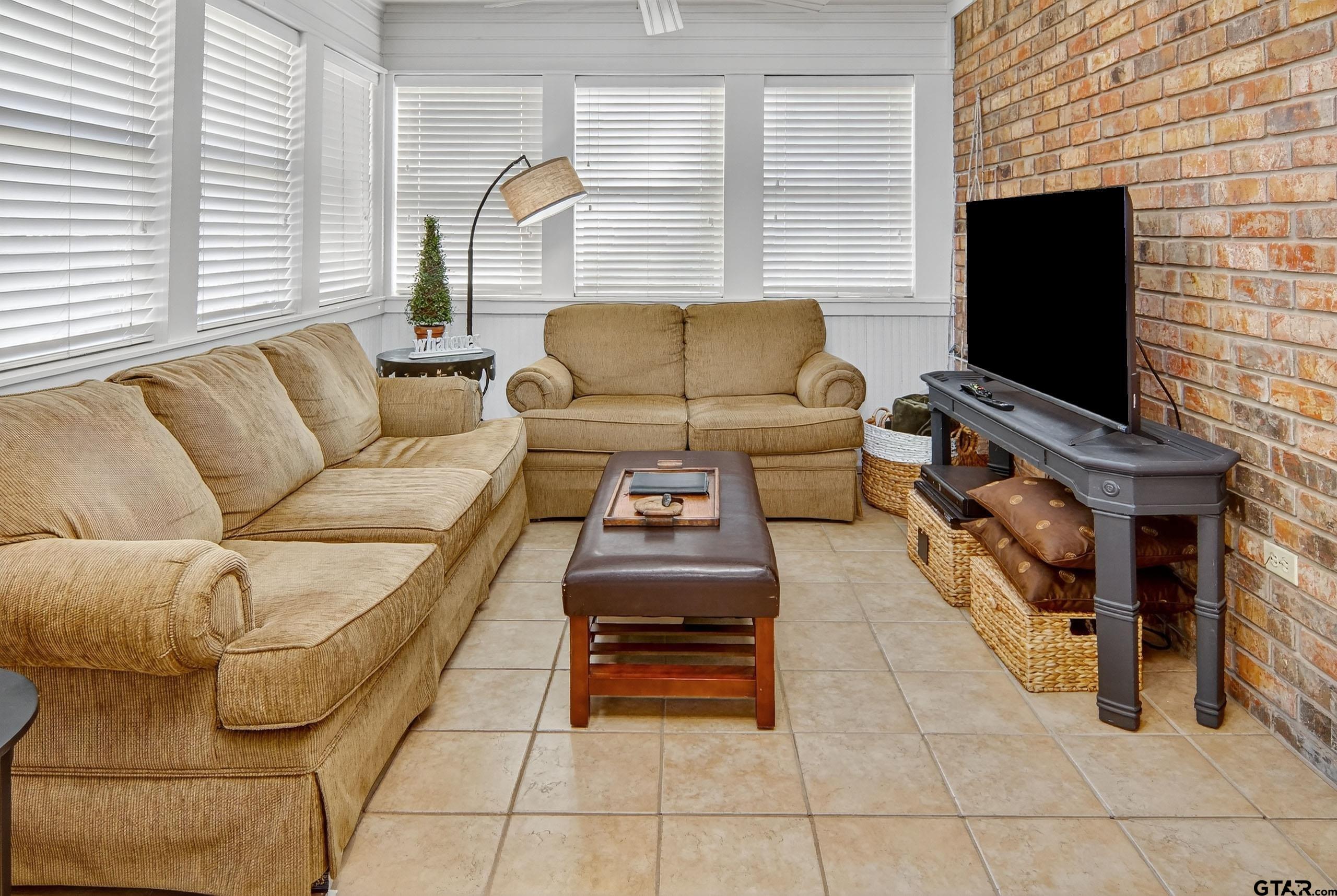 810 Jeanell Street Quitman, TX 75783 - Photo 30 of 37 a living room with furniture and a flat screen tv