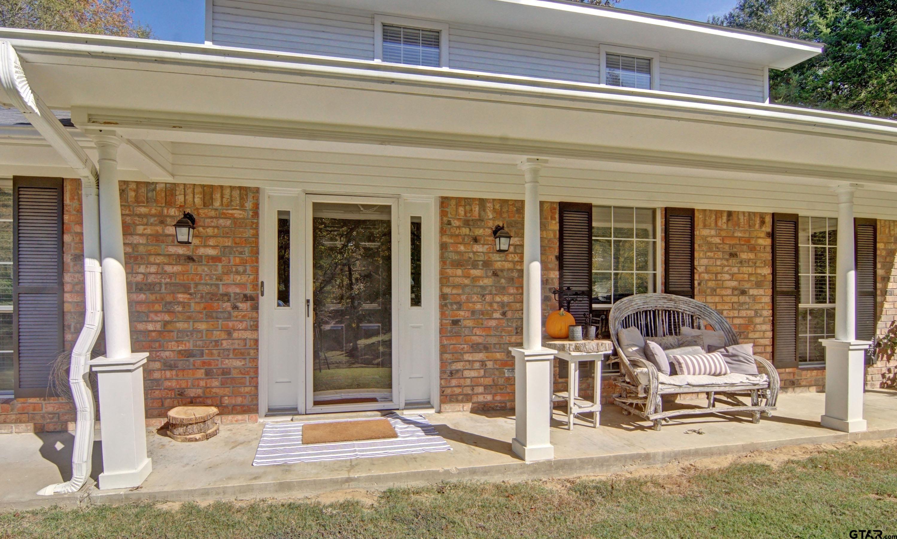 810 Jeanell Street Quitman, TX 75783 - Photo 7 of 37 a view of a door with a chair and the terrace of the house