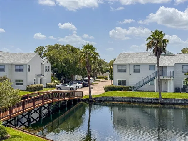 a view of house with swimming pool and outdoor seating