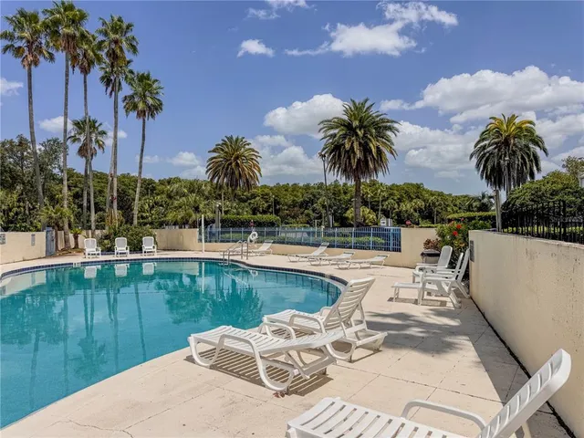 a view of a swimming pool with a table and chairs