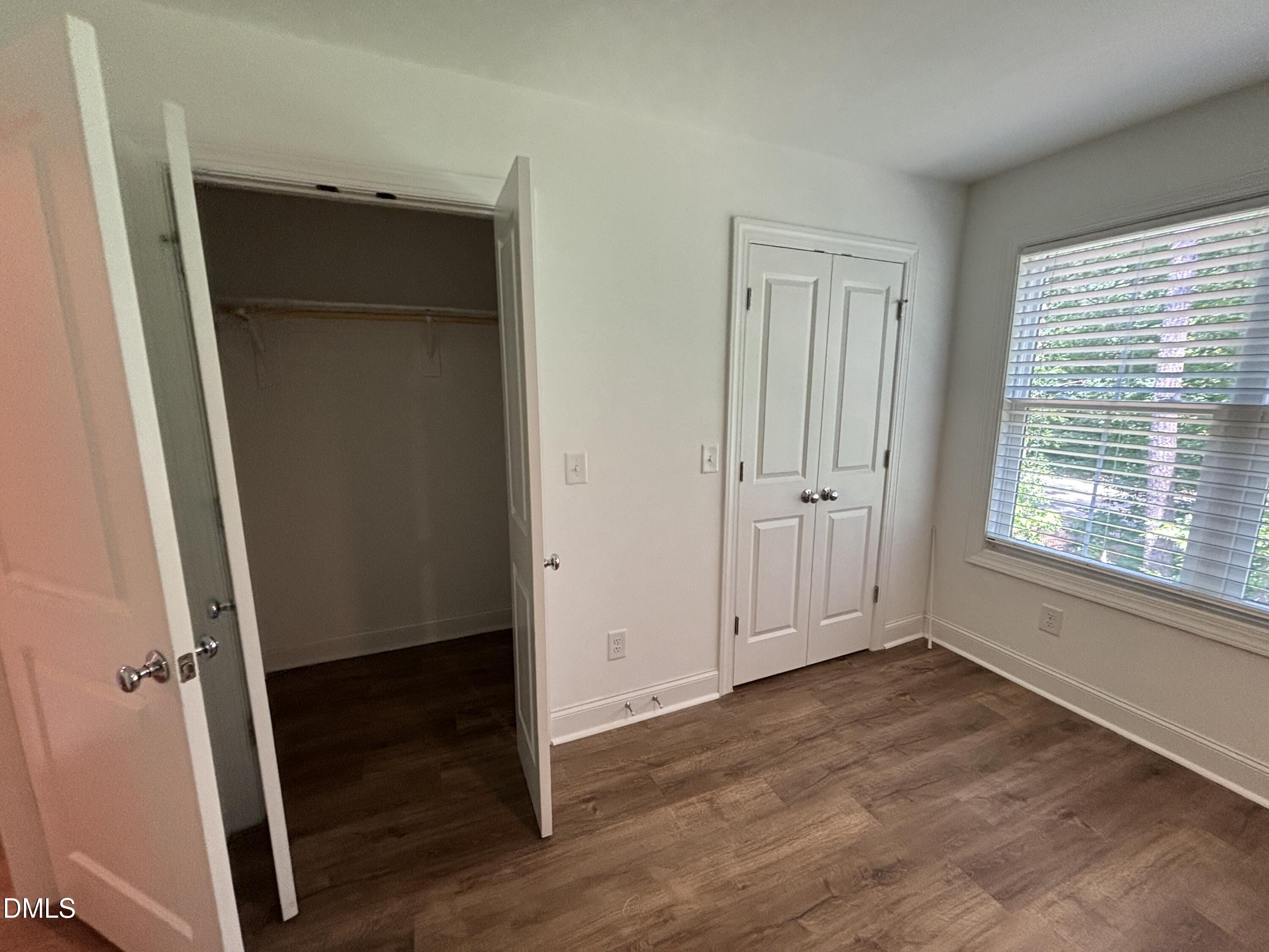 5710 Parker Pnes Court Raleigh, NC 27609 - Photo 46 of 78 an empty room with wooden floor cabinet and windows