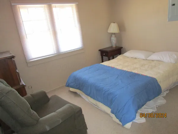 a bedroom with a bed and window