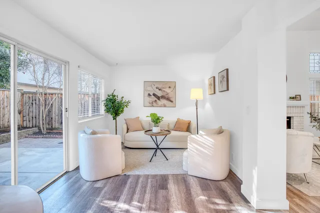 a living room with furniture and wooden floor