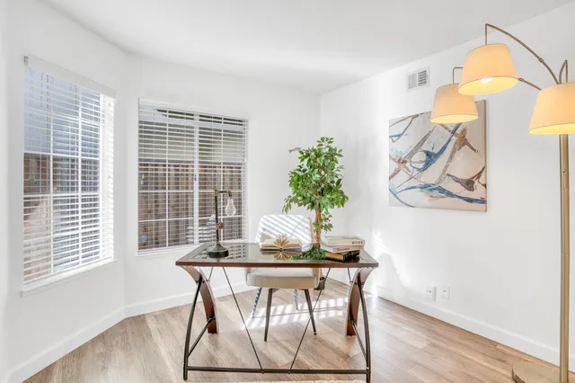 a dining room with furniture and window