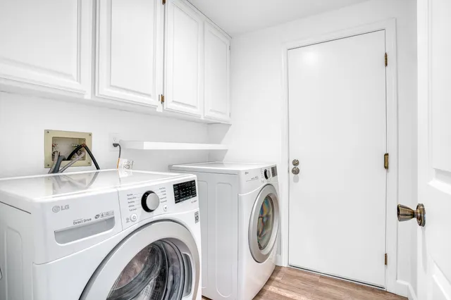 a view of washer and dryer with kitchen in the background