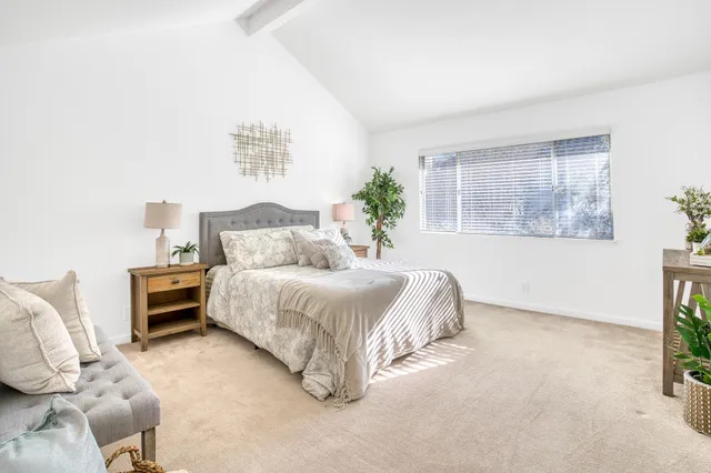 a spacious bedroom with a bed and a window