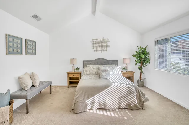 a bedroom with a bed and a couch