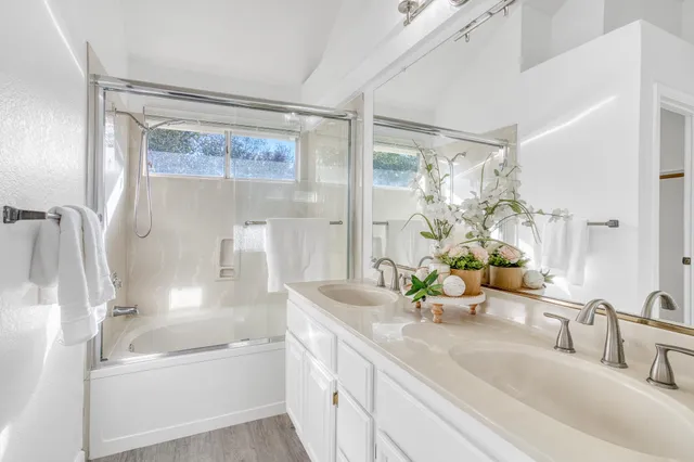 a bathroom with a tub sink and mirror