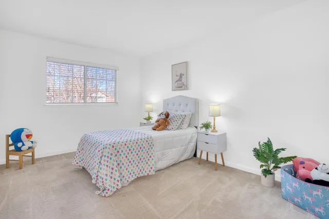 a bed room with a bed and a potted plant