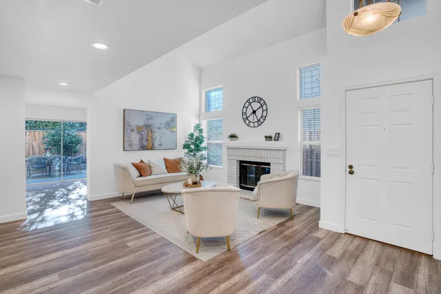 a living room with furniture a fireplace and a table