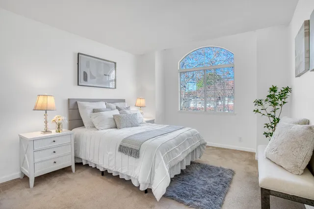 a bedroom with a bed and a window