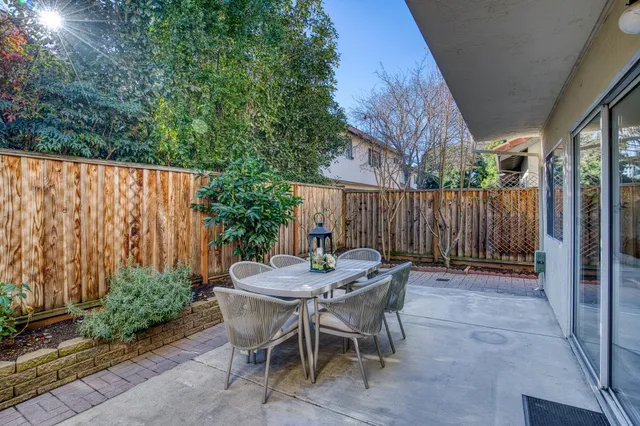 a view of outdoor dining space with a table and chairs