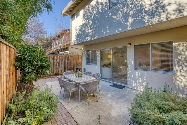 a view of a house with backyard and sitting area