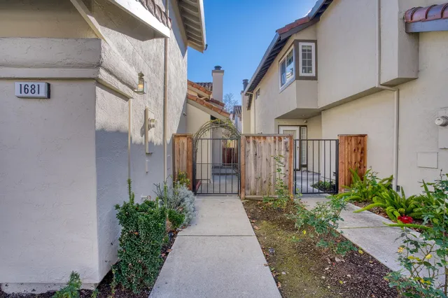 a view of a pathway both side of house