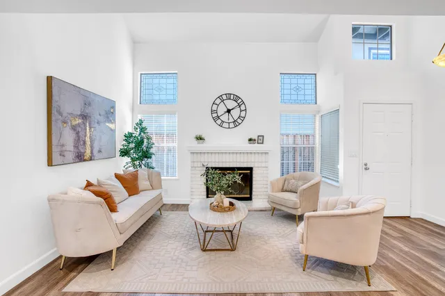 a living room with furniture and a fireplace