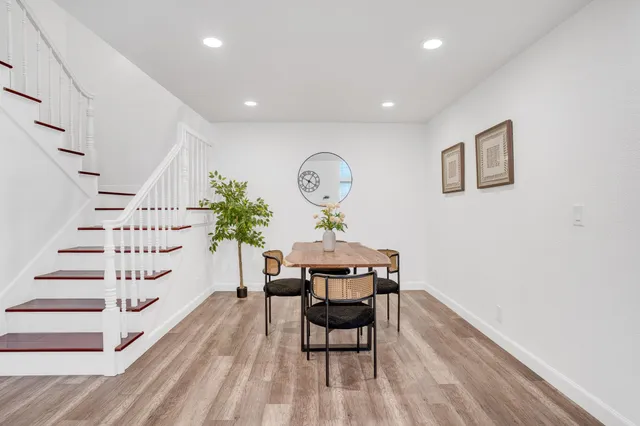 a view of a room with furniture and wooden floor