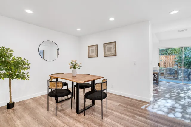 a dining room with furniture and wooden floor