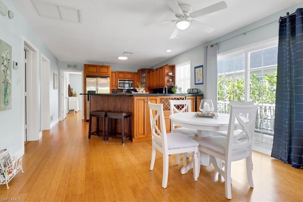 370 Leawood Circle Naples, FL 34104 - Photo 13 of 31 a view of a dining room with furniture window and wooden floor