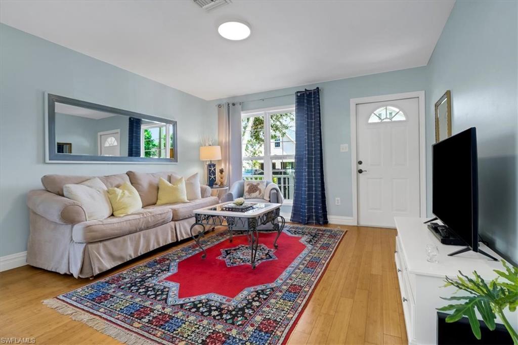 370 Leawood Circle Naples, FL 34104 - Photo 14 of 31 a living room with furniture and a flat screen tv