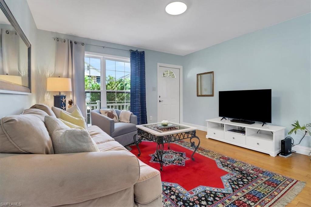 370 Leawood Circle Naples, FL 34104 - Photo 15 of 31 a living room with furniture and a flat screen tv