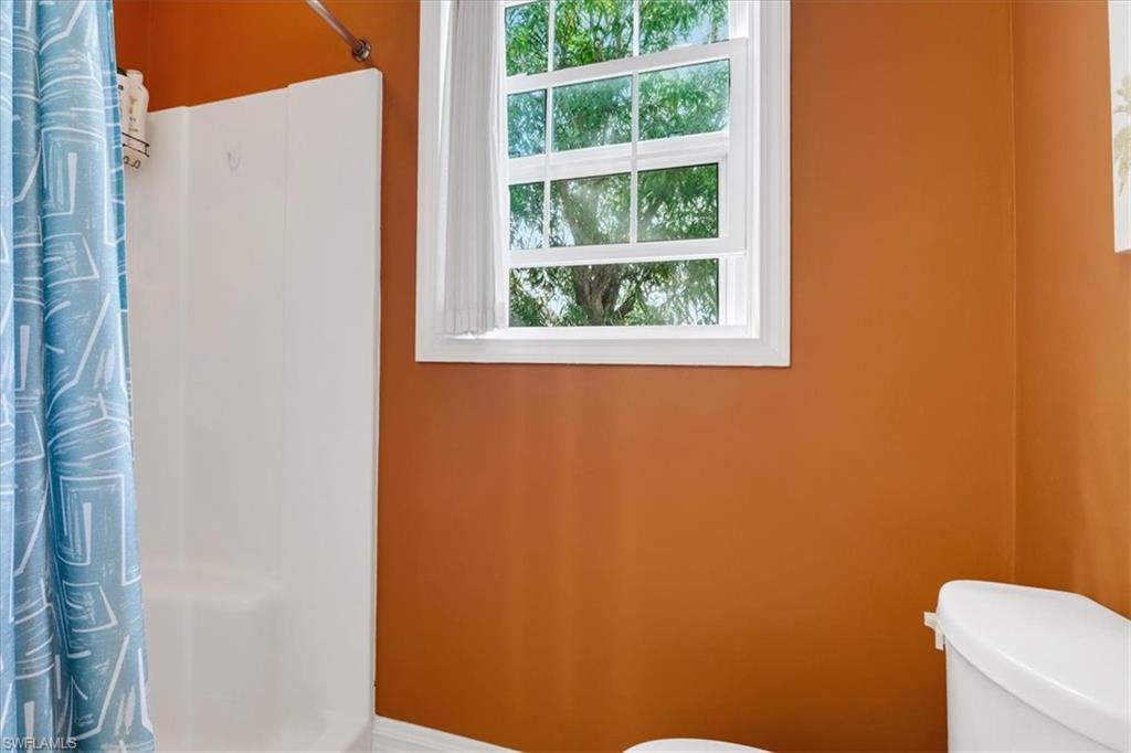 370 Leawood Circle Naples, FL 34104 - Photo 19 of 31 Bathroom with curtained shower and toilet