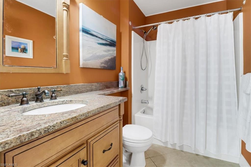 370 Leawood Circle Naples, FL 34104 - Photo 22 of 31 a bathroom with a granite countertop sink and a mirror