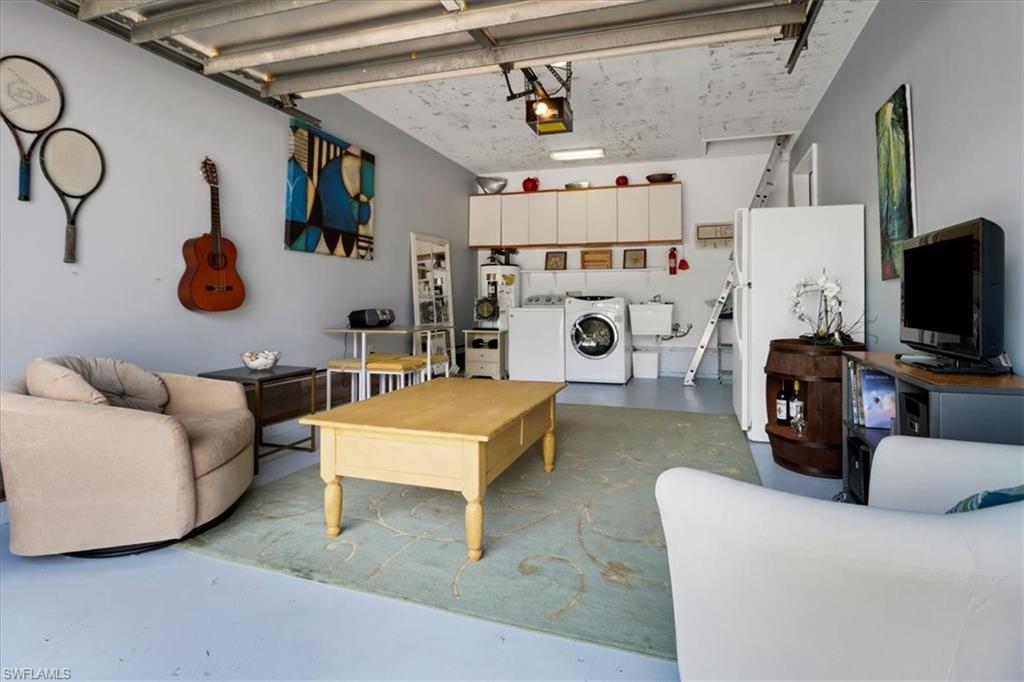 370 Leawood Circle Naples, FL 34104 - Photo 25 of 31 a living room with furniture and a flat screen tv