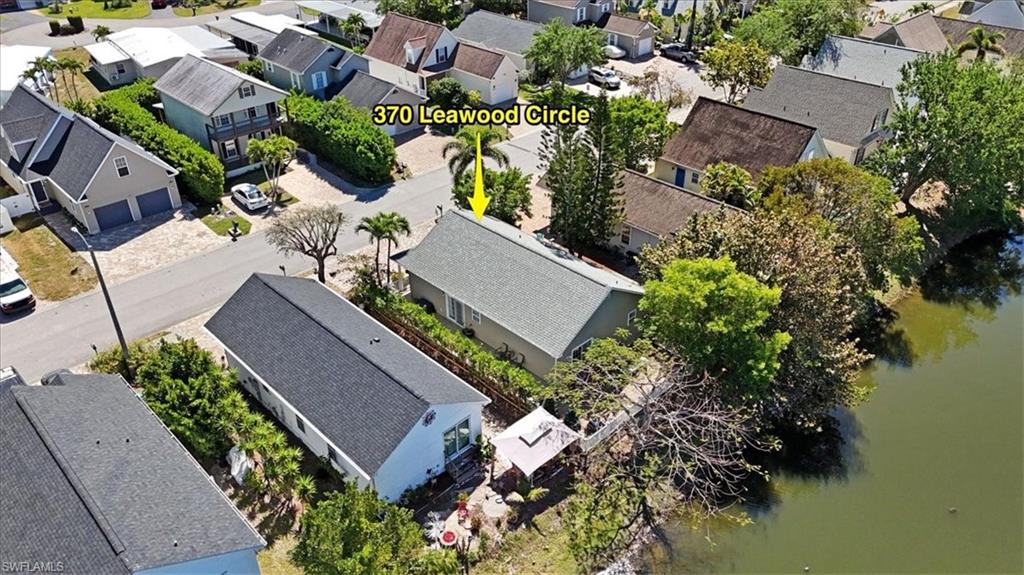 370 Leawood Circle Naples, FL 34104 - Photo 28 of 31 an aerial view of a house with a lake view