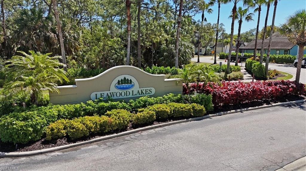 370 Leawood Circle Naples, FL 34104 - Photo 31 of 31 a view of a garden with a wooden fence