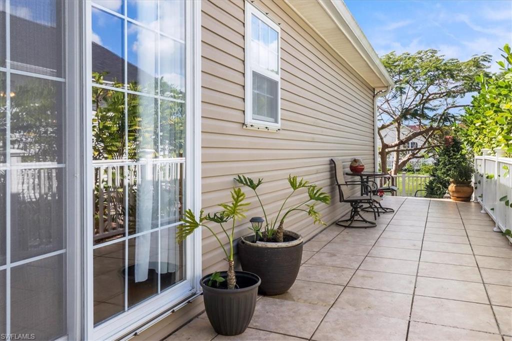 370 Leawood Circle Naples, FL 34104 - Photo 7 of 31 a potted plant sitting on a brick wall