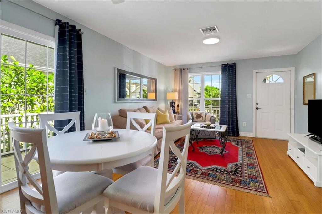 370 Leawood Circle Naples, FL 34104 - Photo 8 of 31 a living room with furniture and a flat screen tv