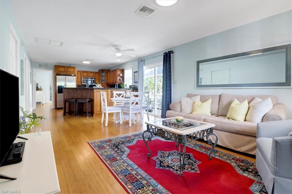 370 Leawood Circle Naples, FL 34104 - Photo 10 of 31 a living room with furniture and a flat screen tv