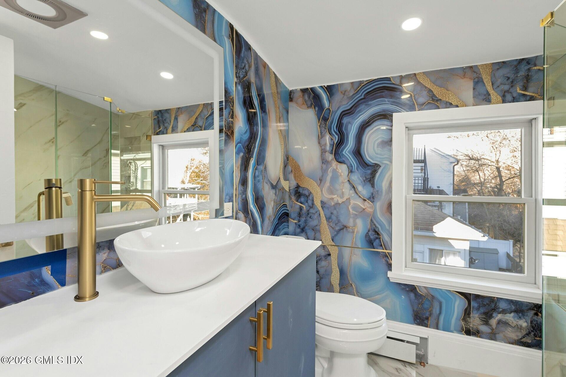 71 Prospect Street, Unit 2 Greenwich, CT 06830 - Photo 15 of 17 a bathroom with a sink a toilet and a mirror