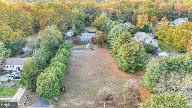 a view of a garden with lawn chairs under an umbrella