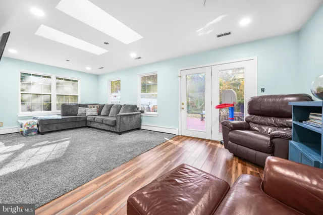a bedroom with furniture and a flat screen tv