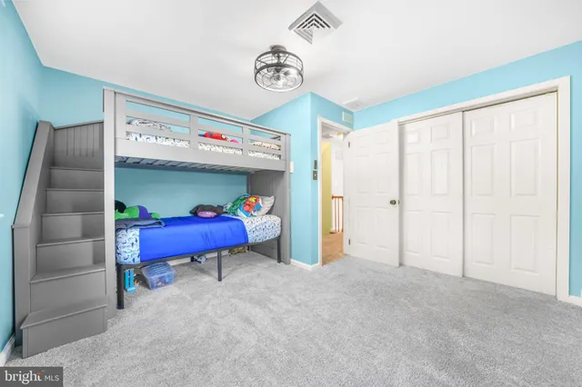 a bedroom with bed and a chandelier
