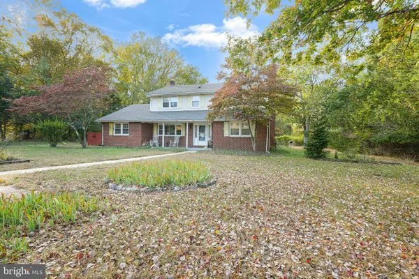 a view of a dirt road and a building