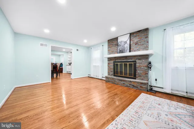 a dining room with furniture and wooden floor