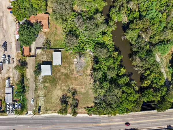 an aerial view of a residential houses with yard