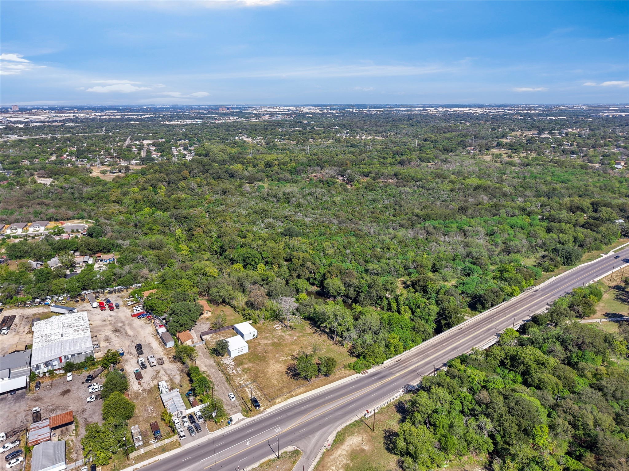 2111 Rigsby Avenue San Antonio, TX 78210 - Photo 4 of 21 a view of a green field with lots of trees in the background
