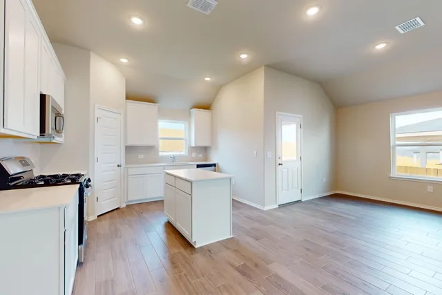 a kitchen with a sink cabinets and a window