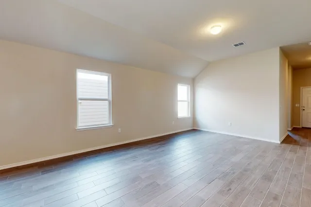 a view of a room with wooden floor