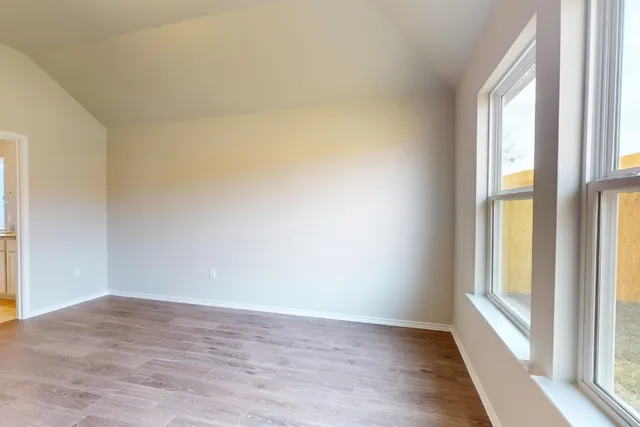 a view of a room with wooden floor