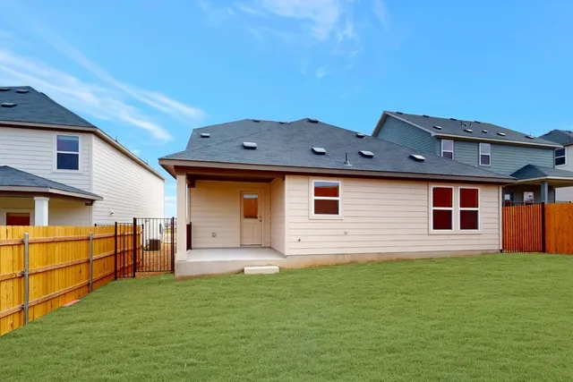 a view of a house with a backyard